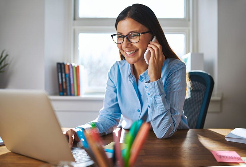 Woman Business Owner on Laptop and Phone